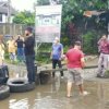 FOTO: Diduga Kesal karena Selalu Tergenang Air, Warga Kota Makassar Blokir Lalin dan Tanam Pisang di Tengah Jalan