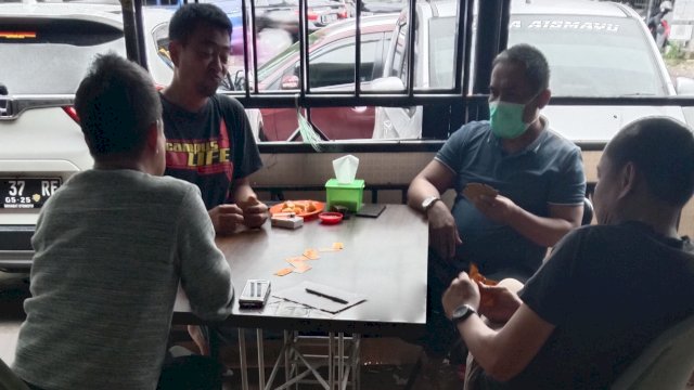 Tampak warga sedang bermain domino di salah satu warkop di Kecamatan Panakkukang, Makassar. Minggu (6/3).