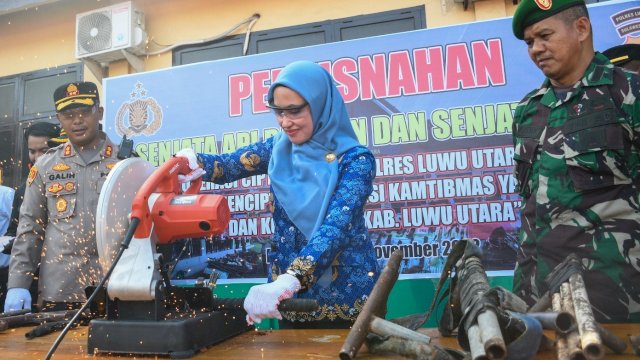 Bupati Luwu Utara Indah Putri Indriani Memotong Menggunakan Mesin pemotong Senjata Api Rakitan Yang d Sita Jajaran TNI Polri di Wilayah Hukum Pemda Lutra